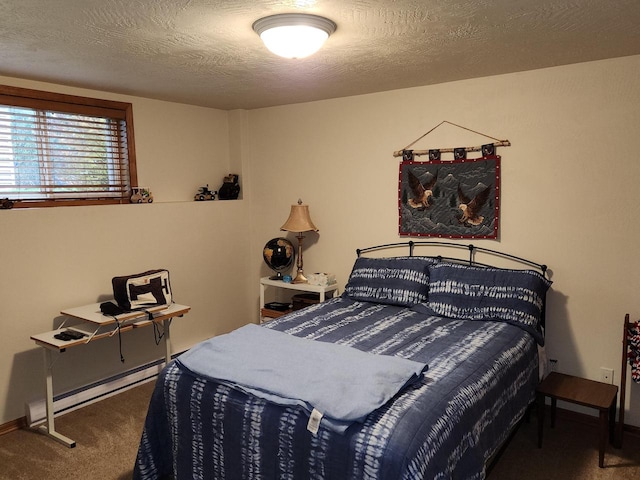 carpeted bedroom featuring a baseboard heating unit and a textured ceiling