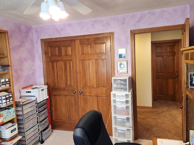 office space featuring ceiling fan and light carpet