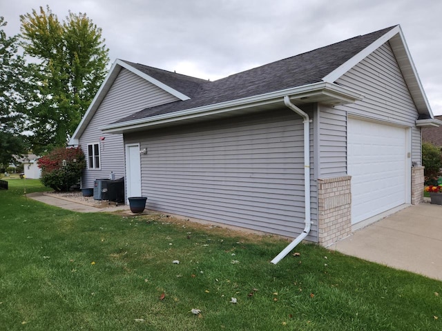 view of property exterior featuring a yard, cooling unit, and a garage