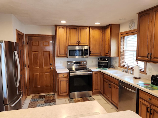 kitchen featuring appliances with stainless steel finishes, sink, and light tile patterned floors