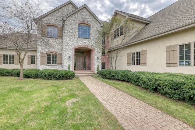 french country home with a front lawn