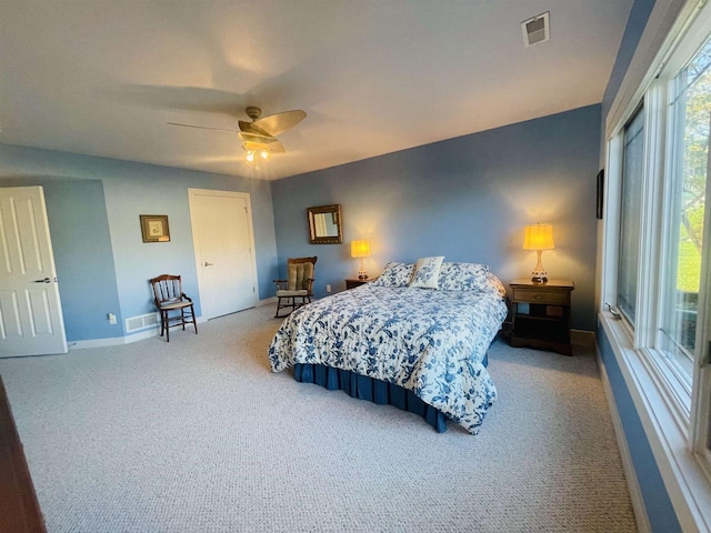 bedroom featuring light carpet and ceiling fan