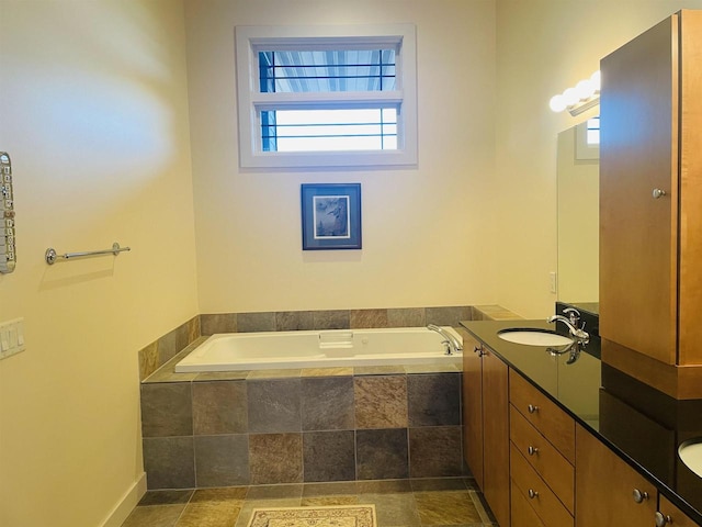 bathroom with vanity and tiled bath