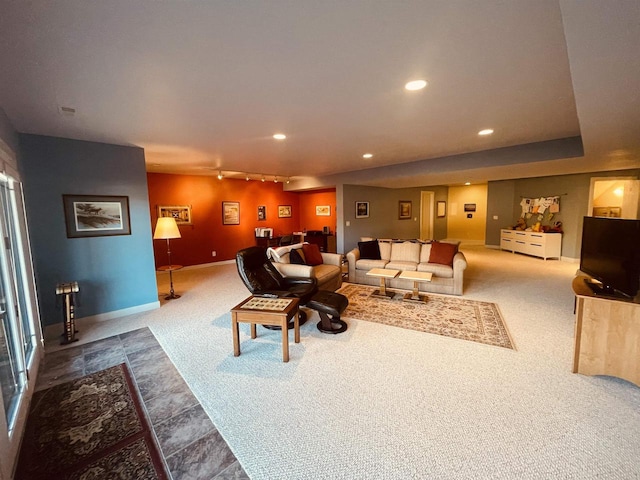 carpeted living room with track lighting