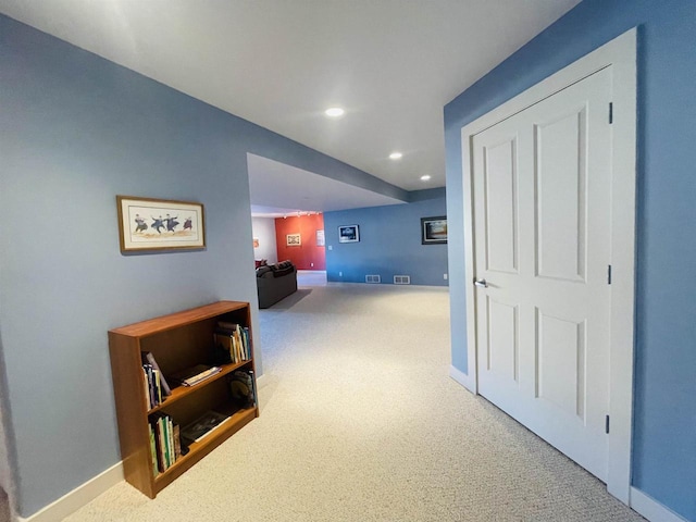 hallway with carpet floors