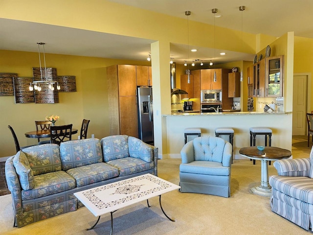 living room with light carpet and a chandelier