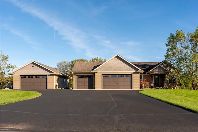 craftsman-style home with a garage and a front lawn