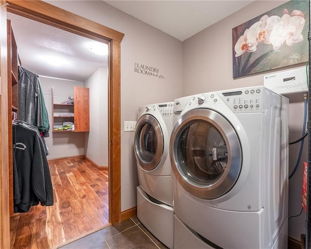 washroom with wood-type flooring and separate washer and dryer