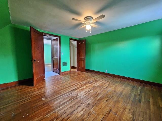 unfurnished bedroom featuring ceiling fan and hardwood / wood-style flooring