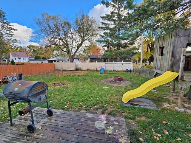 view of yard with a playground and a wooden deck