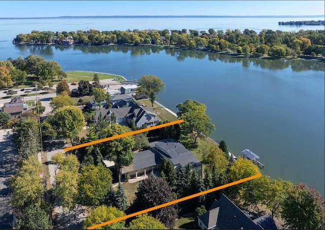 birds eye view of property with a water view