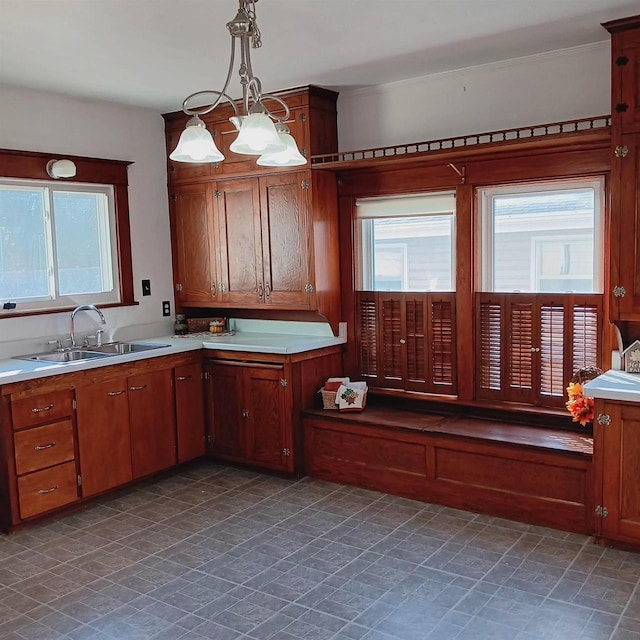 kitchen with sink, a notable chandelier, and decorative light fixtures