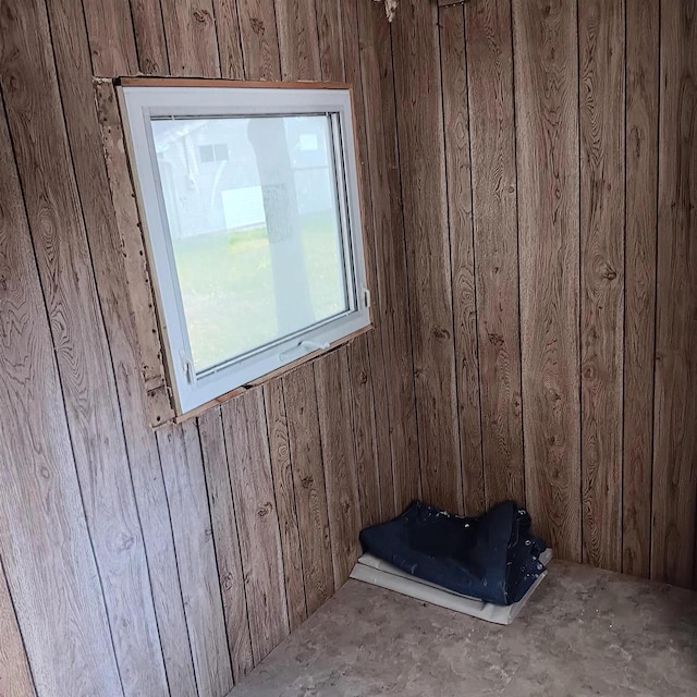 unfurnished room featuring wood walls