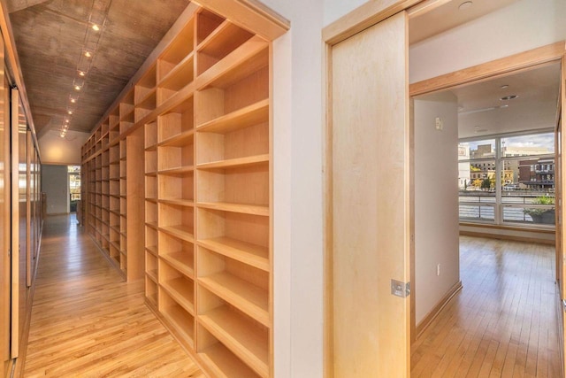 hallway featuring light hardwood / wood-style floors and wooden ceiling