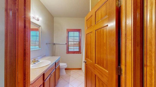 bathroom with tile patterned flooring, vanity, and toilet