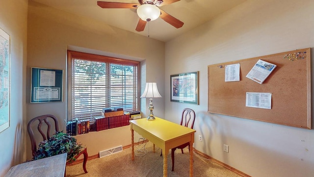 carpeted office space with ceiling fan