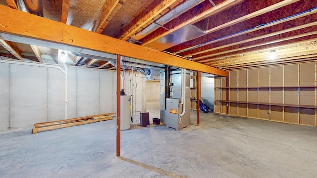 basement with gas water heater and heating unit