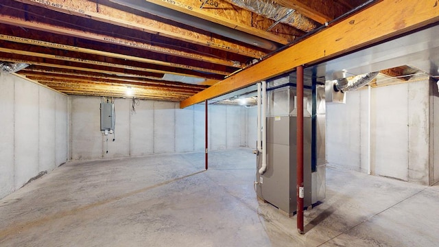 basement with electric panel and heating unit