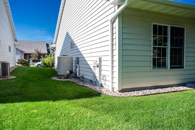 view of home's exterior with a yard and central AC unit