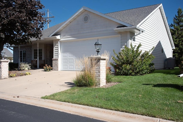 single story home featuring a garage and a front lawn