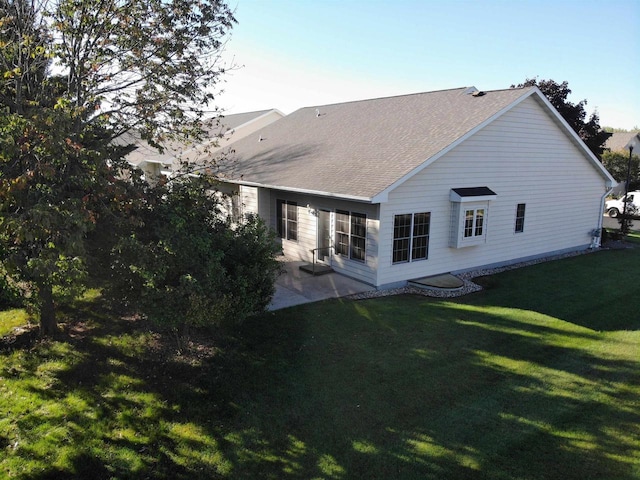 back of house featuring a yard and a patio area