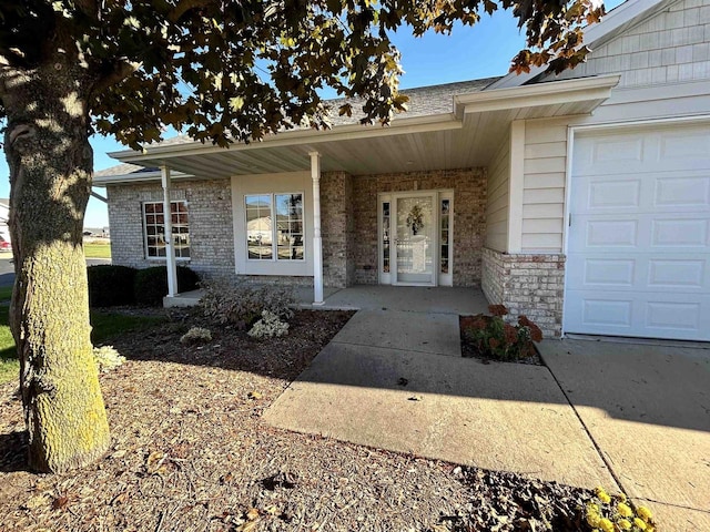 doorway to property with a garage