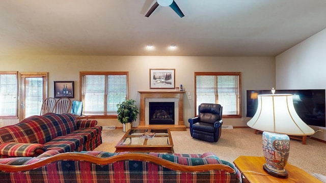 carpeted living room featuring ceiling fan