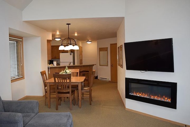 dining area featuring light colored carpet and a baseboard radiator