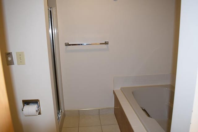 bathroom with plus walk in shower and tile patterned flooring