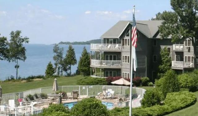 exterior space featuring a water view and a pool