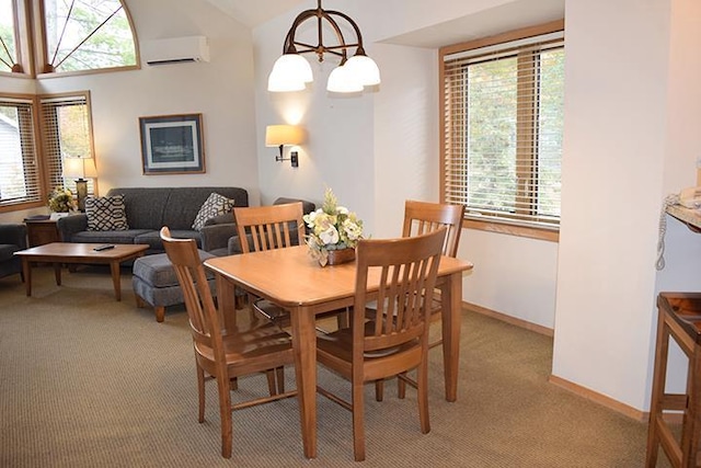 carpeted dining space featuring a wall mounted air conditioner, vaulted ceiling, and an inviting chandelier