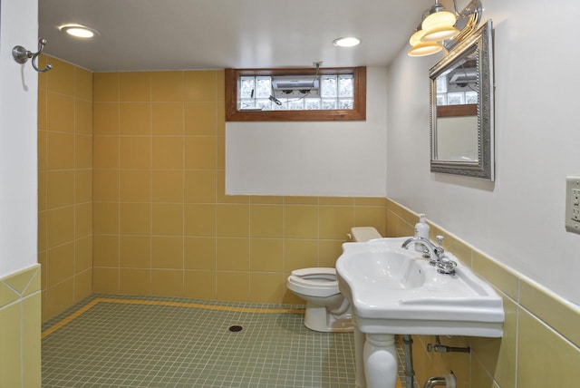 bathroom featuring sink, tile walls, tile patterned flooring, and toilet