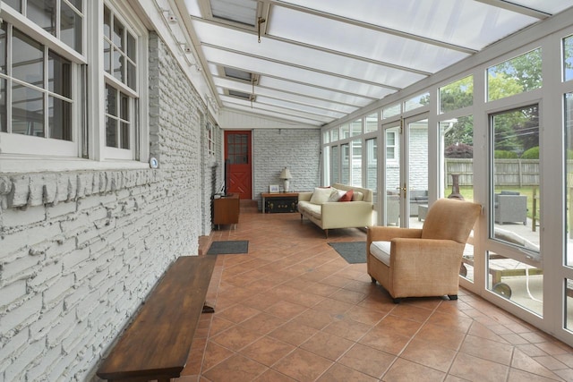 sunroom featuring lofted ceiling