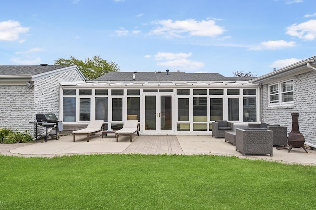 rear view of property with an outdoor living space, a yard, and a patio area