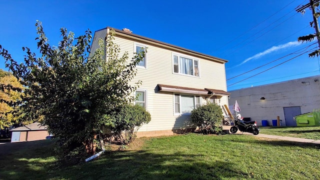 rear view of house featuring a lawn