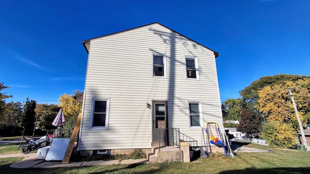 rear view of house with a lawn