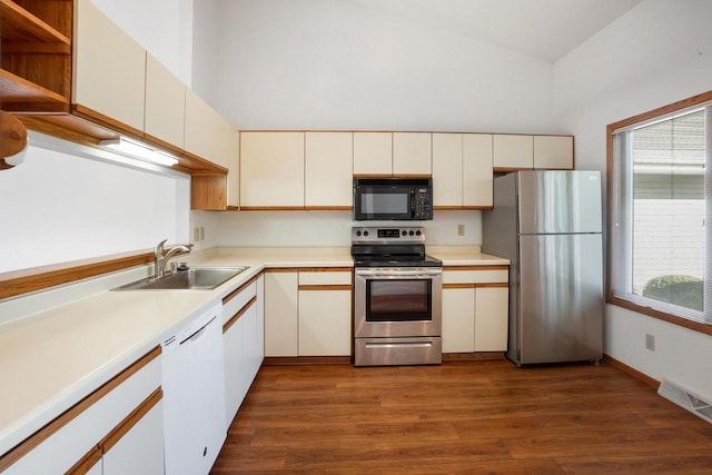 kitchen featuring appliances with stainless steel finishes, sink, a wealth of natural light, and dark hardwood / wood-style floors