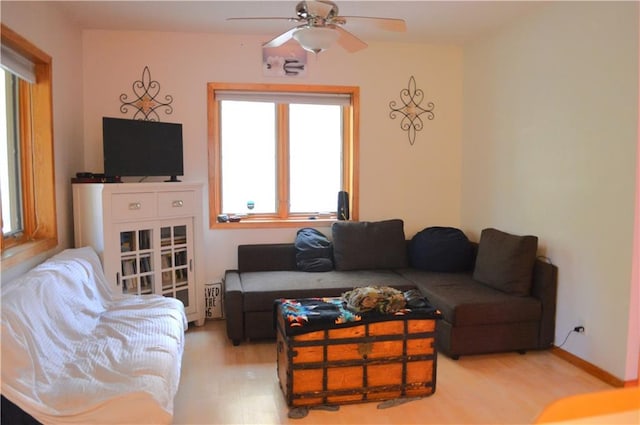 living room featuring ceiling fan and hardwood / wood-style floors