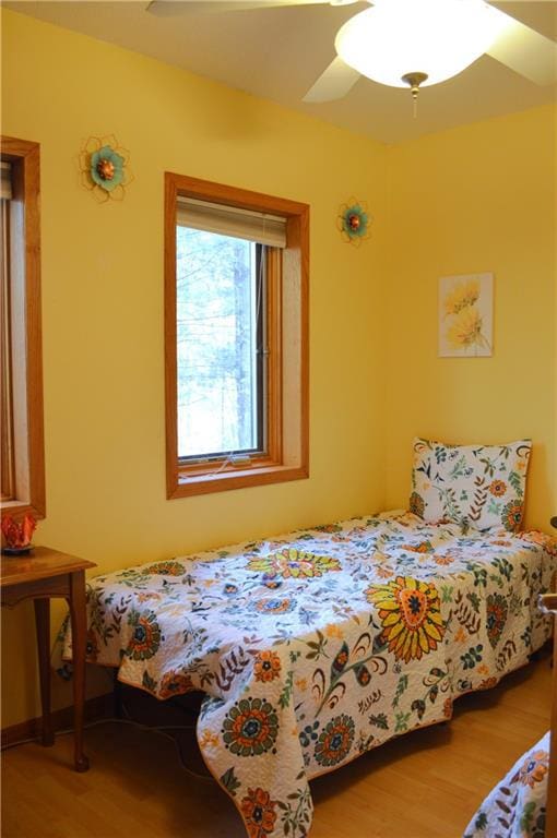 bedroom featuring hardwood / wood-style flooring and ceiling fan