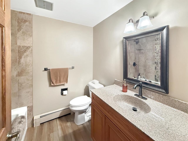 bathroom featuring vanity, a baseboard radiator, hardwood / wood-style flooring, and toilet