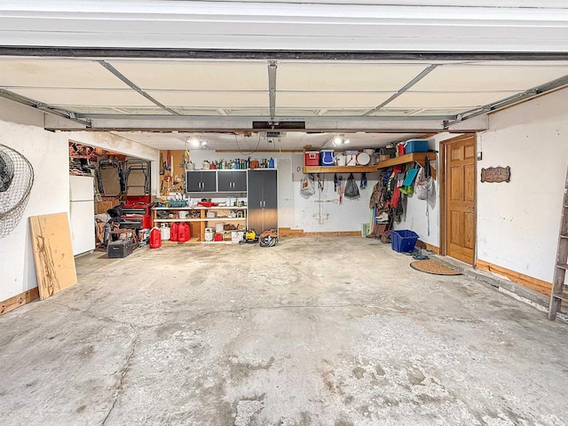 garage with a workshop area and white refrigerator