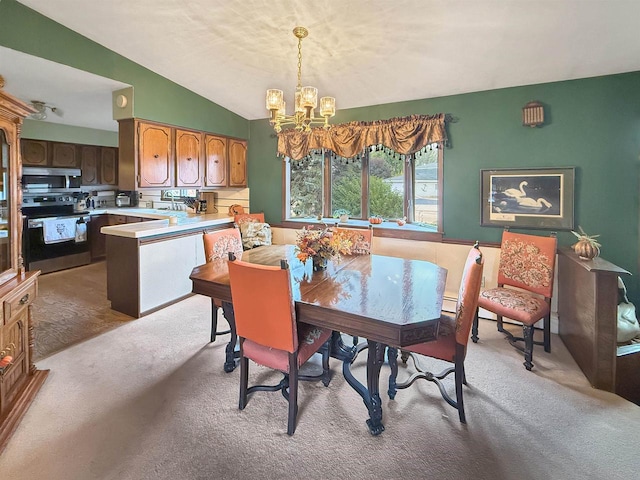 dining room featuring light carpet, an inviting chandelier, and vaulted ceiling