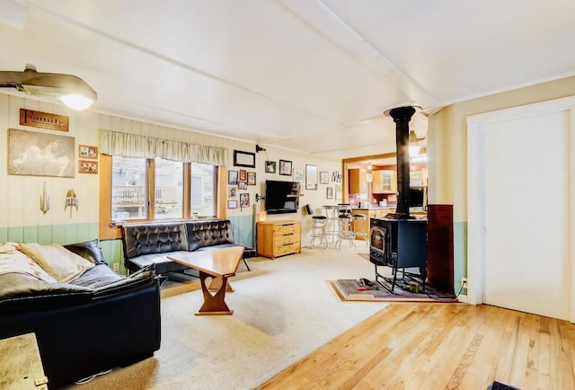 living room featuring a wood stove and hardwood / wood-style floors