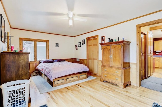 bedroom with ornamental molding, light wood-type flooring, and ceiling fan