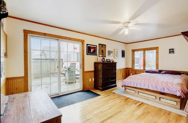 bedroom featuring multiple windows, access to exterior, light wood-type flooring, and ceiling fan