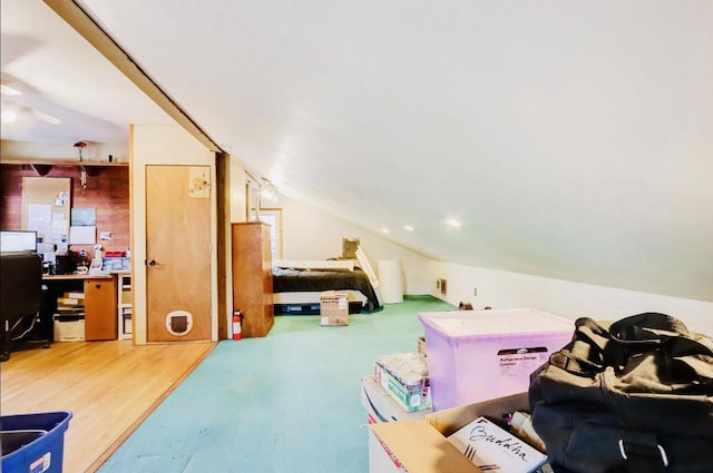 bedroom with lofted ceiling and hardwood / wood-style floors