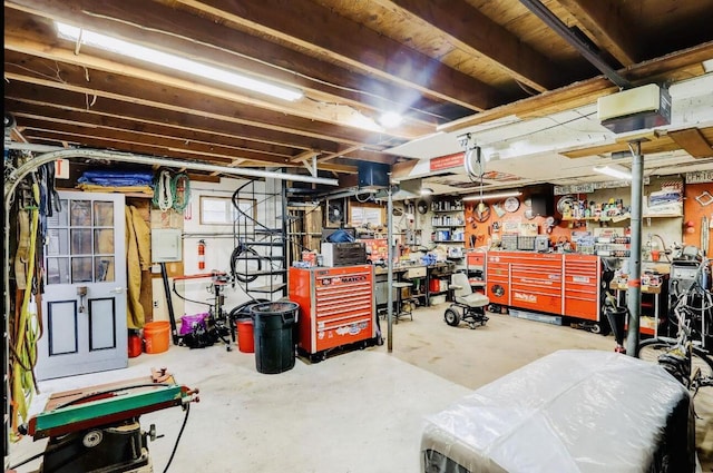 garage with a garage door opener and a workshop area