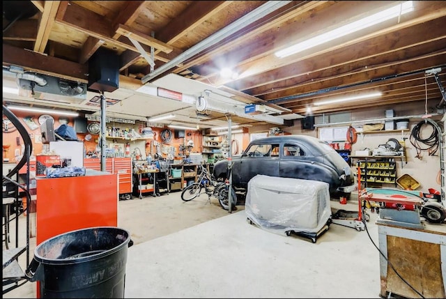 garage featuring a garage door opener and a workshop area