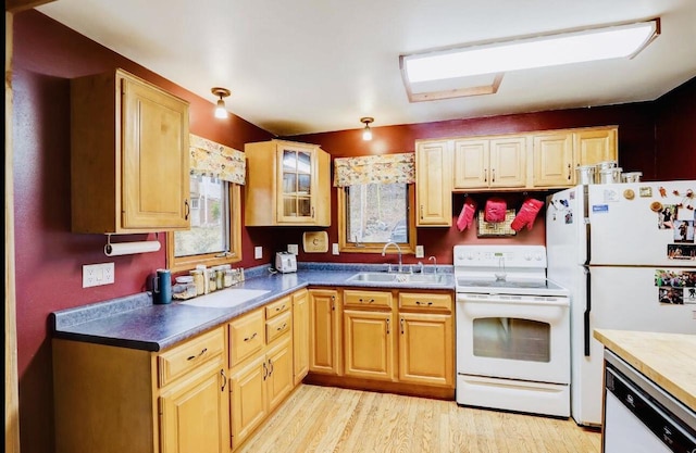 kitchen featuring white appliances, sink, and light wood-type flooring