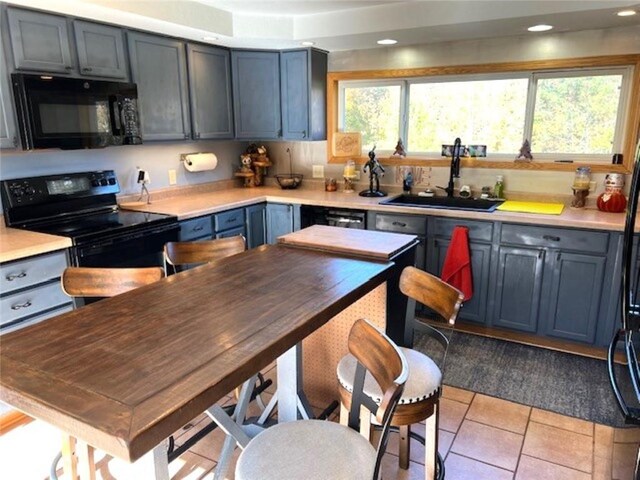 345 Old County D, Shell Lake, WI 54871 - kitchen featuring a sink, light tile patterned flooring, recessed lighting, light countertops, and black appliances
